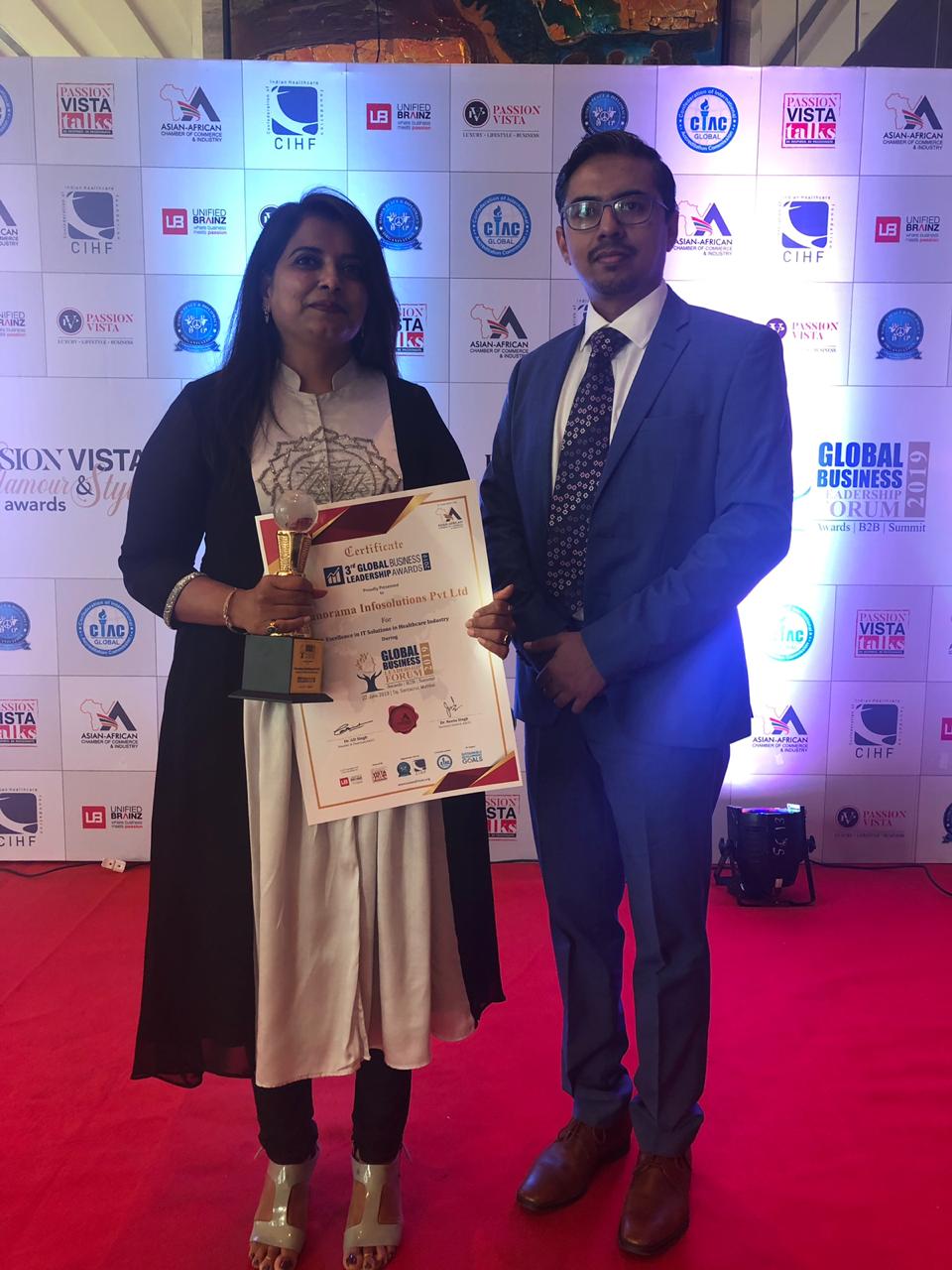 Ashvini Danigond and puneet pantane recieving Excellence in IT Solutions in Healthcare Industry Award